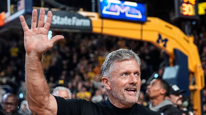 Michigan football head coach Kyle Whittingham waves at the crowd as he is being introduced on the floor during the first half between Michigan and USC at Crisler Center in Ann Arbor on Friday, Jan. 2, 2026. Michigan football head coach Kyle Whittingham waves at the crowd as he is being introduced on the floor during the first half between Michigan and USC at Crisler Center in Ann Arbor on Friday, Jan. 2, 2026.