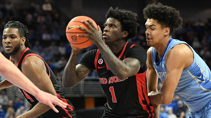 Dec 31, 2024; Omaha, Nebraska, USA;  St. John's basketball guard Kadary Richmond (1) drives against Creighton Bluejays forward Jasen Green (0) during the first half at CHI Health Center Omaha.
