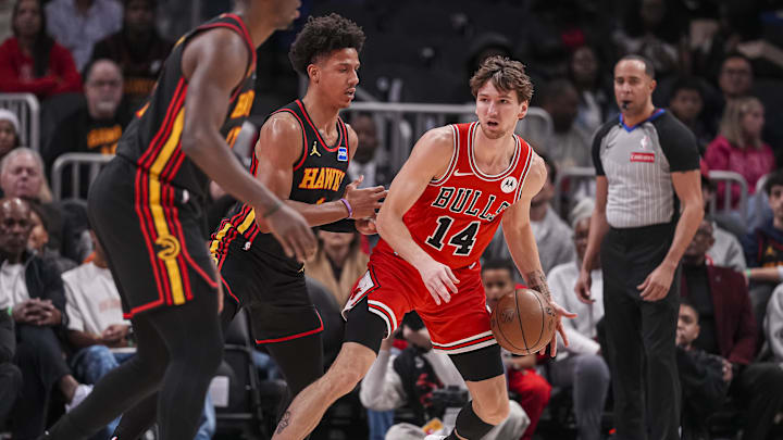 Dec 21, 2025; Atlanta, Georgia, USA; Chicago Bulls forward Matas Buzelis (14) dribbles guarded by Atlanta Hawks forward Jalen Johnson (1) during the first half at State Farm Arena. Mandatory Credit: Dale Zanine-Imagn Images