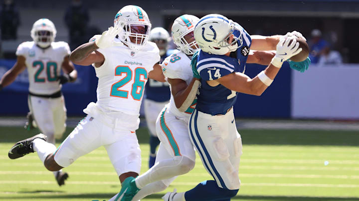 Sep 7, 2025; Indianapolis, Indiana, USA; Indianapolis Colts wide receiver Alec Pierce (14) makes a catch against Miami Dolphins cornerback Rasul Douglas (26) and safety Minkah Fitzpatrick (29)