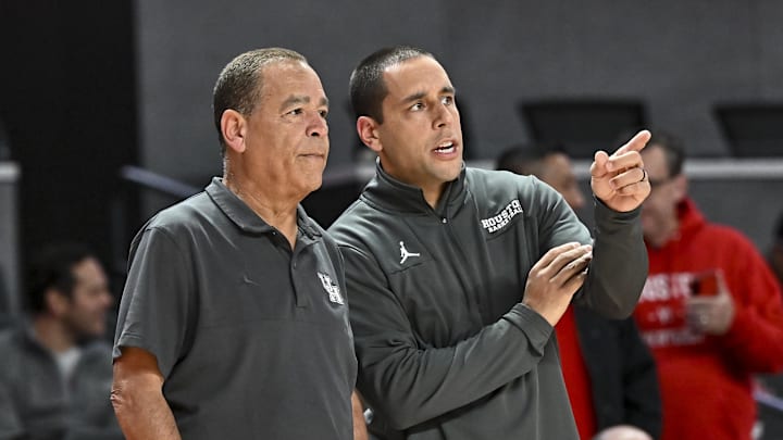 Nov 14, 2022; Houston, Texas, USA; Houston Cougars head coach Kelvin Sampson speaks with assistant coach Kellen Sampson prior to the game against the Oral Roberts Golden Eagles at Fertitta Center. Mandatory Credit: Maria Lysaker-Imagn Images