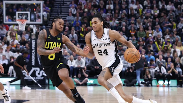 Mar 27, 2024; Salt Lake City, Utah, USA; San Antonio Spurs guard Devin Vassell (24) drives as Utah Jazz forward Brice Sensabaugh (8) defends during the third quarter at Delta Center. Mandatory Credit: Rob Gray-Imagn Images