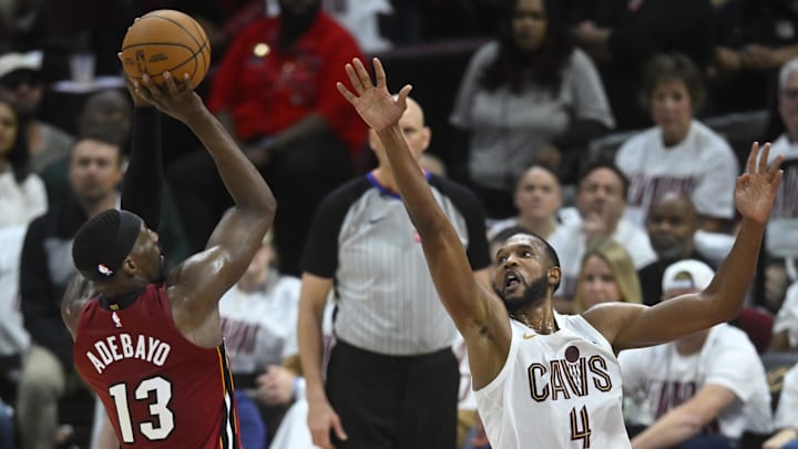 Apr 20, 2025; Cleveland, Ohio, USA; Miami Heat center Bam Adebayo (13) shoots beside Cleveland Cavaliers forward Evan Mobley (4) in the fourth quarter at Rocket Arena. Mandatory Credit: David Richard-Imagn Images
