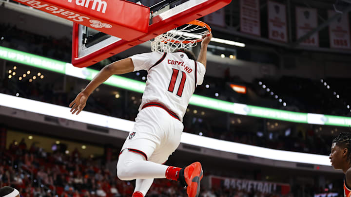 Jan 27, 2026; Raleigh, North Carolina, USA; NC State Wolfpack guard Quadir Copeland (11) dunks the ball during the first half of the game against the Syracuse Orange at Lenovo Center. Mandatory Credit: Jaylynn Nash-Imagn Images