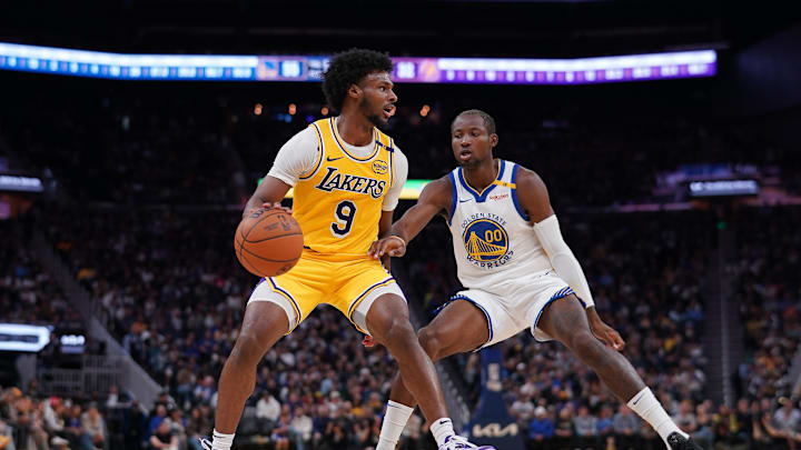 Oct 18, 2024; San Francisco, California, USA; Los Angeles Lakers guard Bronny James (9) dribbles the ball next to Golden State Warriors forward Jonathan Kuminga (00) in the second quarter at the Chase Center. Mandatory Credit: Cary Edmondson-Imagn Images