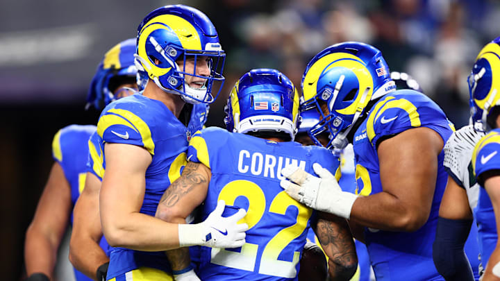 Dec 18, 2025; Seattle, Washington, USA; Los Angeles Rams running back Blake Corum (22) celebrates with quarterback Matthew Stafford (9) after a touchdown against the Seattle Seahawks in the second half at Lumen Field. Mandatory Credit: Kevin Ng-Imagn Images