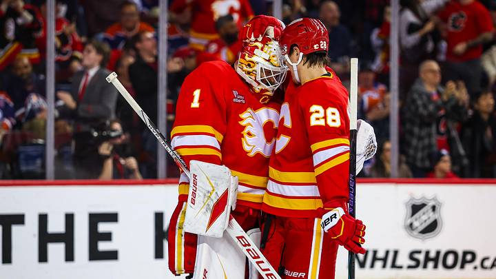 Feb 4, 2026; Calgary, Alberta, CAN; Calgary Flames goaltender Devin Cooley (1) celebrates win with teammates after defeating Edmonton Oilers at Scotiabank Saddledome. Mandatory Credit: Sergei Belski-Imagn Images