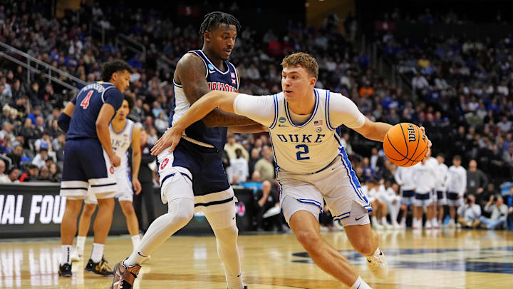 Mar 27, 2025; Newark, NJ, USA; Duke Blue Devils forward Cooper Flagg (2) drives to the basket against Arizona Wildcats guard Jaden Bradley (0) during the second half during an East Regional semifinal of the 2025 NCAA tournament at Prudential Center. Mandatory Credit: Robert Deutsch-Imagn Images