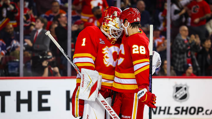 Feb 4, 2026; Calgary, Alberta, CAN; Calgary Flames goaltender Devin Cooley (1) celebrates win with teammates after defeating Edmonton Oilers at Scotiabank Saddledome. Mandatory Credit: Sergei Belski-Imagn Images
