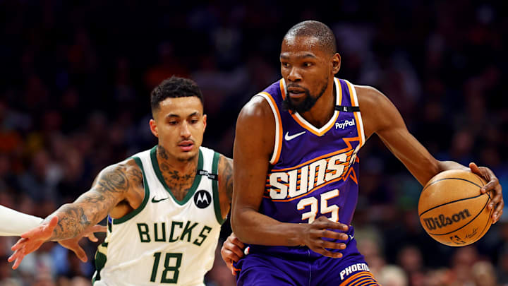 Phoenix Suns forward Kevin Durant handles the ball against Milwaukee Bucks forward Kyle Kuzma.