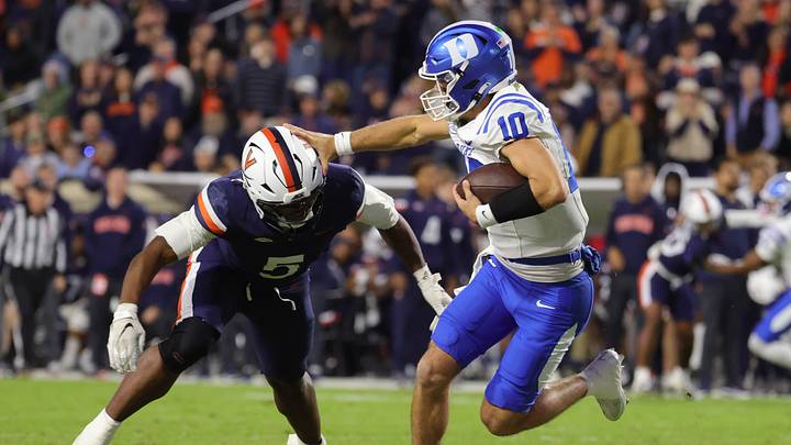 Oct 23, 2026; Charlottesville, Virginia, USA; Duke Blue Devils quarterback Dan Mahan (10) carries the ball as Virginia Cavaliers linebacker Kam Robinson (5) defends during the first half at Scott Stadium. Mandatory Credit: Amber Searls-Imagn Images Oct 23, 2026; Charlottesville, Virginia, USA; Duke Blue Devils quarterback Dan Mahan (10) carries the ball as Virginia Cavaliers linebacker Kam Robinson (5) defends during the first half at Scott Stadium. Mandatory Credit: Amber Searls-Imagn Images