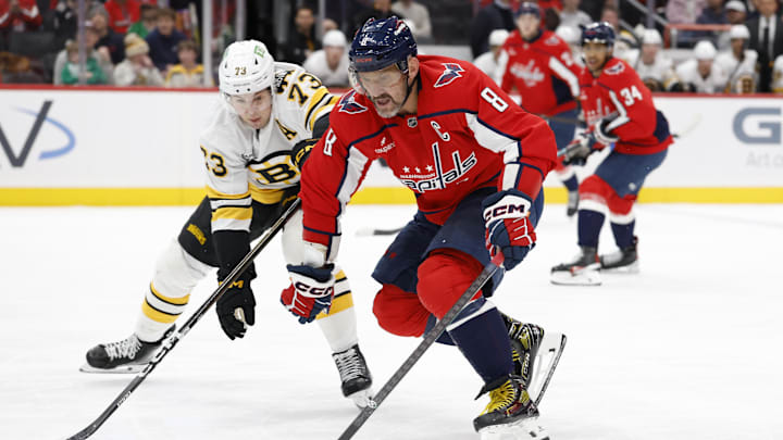 Mar 9, 2026; Washington, District of Columbia, USA; Washington Capitals left wing Alex Ovechkin (8) skates with the puck as Boston Bruins defenseman Charlie McAvoy (73) defends during the first period at Capital One Arena. Mandatory Credit: Geoff Burke-Imagn Images