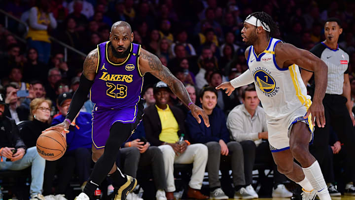 Feb 6, 2025; Los Angeles, California, USA; Los Angeles Lakers forward LeBron James (23) moves the ball against Golden State Warriors guard Buddy Hield (7) during the first half at Crypto.com Arena. Mandatory Credit: Gary A. Vasquez-Imagn Images