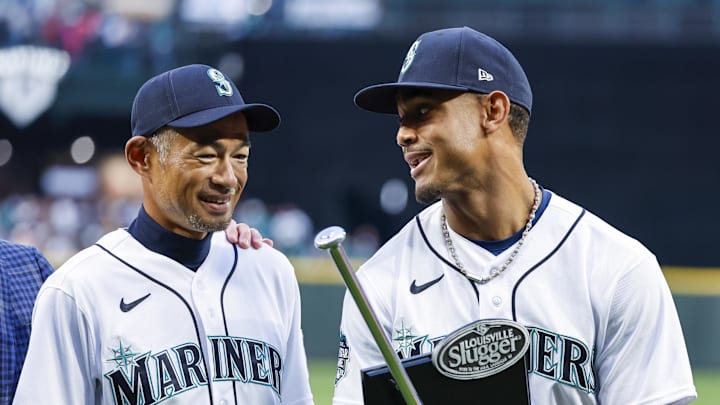 Seattle Mariners center fielder Julio Rodriguez, right, talks with former player Ichiro Suzuki, left, after receiving his Silver Slugger and Rookie of the Year awards before a game against the Cleveland Guardians at T-Mobile Park in 2023.