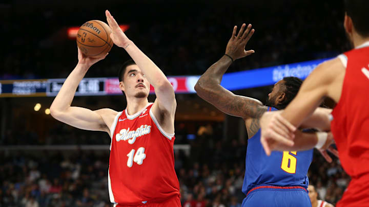 Nov 17, 2024; Memphis, Tennessee, USA; Memphis Grizzlies center Zach Edey (14) shoots as Denver Nuggets center DeAndre Jordan (6) defends during the second half at FedExForum. 