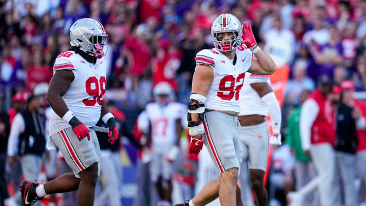 Ohio State Buckeyes defensive end Caden Curry (92) celebrates a sack of Washington Huskies quarterback Demond Williams Jr. (2) during the second half of the NCAA football game at Husky Stadium in Seattle on Sept. 27, 2025. Ohio State won 24-6.