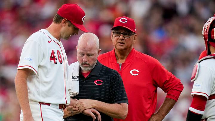 Cincinnati Reds pitcher Nick Lodolo (40) is examined by a trainer after being hit by a line drive in the fourth inning of the MLB National League Central game between the Cincinnati Reds and the Milwaukee Brewers at Great American Ball Park in downtown Cincinnati on Tuesday, June 23, 2026. Cincinnati Reds pitcher Nick Lodolo (40) is examined by a trainer after being hit by a line drive in the fourth inning of the MLB National League Central game between the Cincinnati Reds and the Milwaukee Brewers at Great American Ball Park in downtown Cincinnati on Tuesday, June 23, 2026.