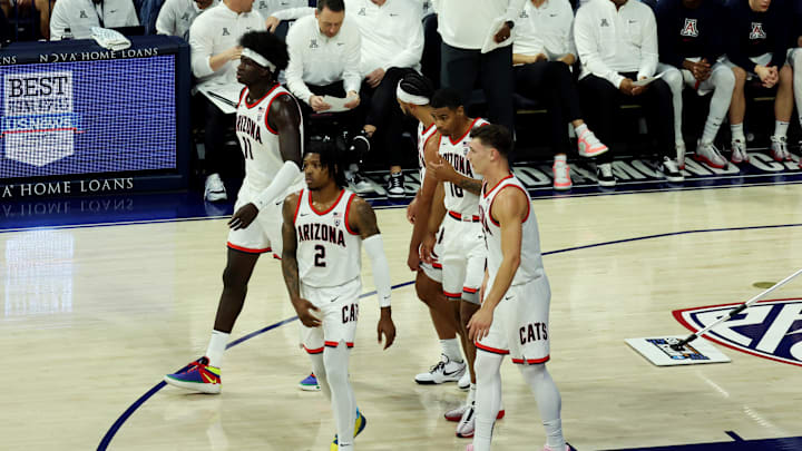 Dec 2, 2023; Tucson, Arizona, USA; Arizona Wildcats guard Caleb Love (2), center Oumar Ballo (11), forward Keshad Johnson (16), guard Pelle Larsson (3), and guard Kylan Boswell (4) walk back onto the court after a timeout during the first half at McKale Center. Mandatory Credit: Zachary BonDurant-Imagn Images
