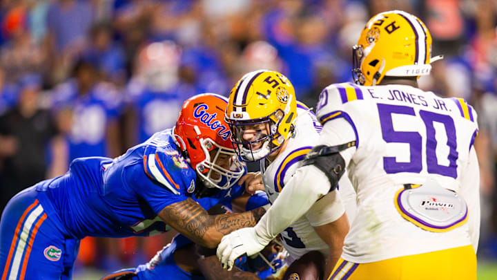 Florida Gators edge T.J. Searcy (19) and Florida Gators edge George Gumbs Jr. (34) sacks LSU Tigers quarterback Garrett Nussmeier (13) causing a fumble during the second half at Ben Hill Griffin Stadium in Gainesville, FL on Saturday, November 16, 2024. The Gators defeated the Tigers 27-16. [Doug Engle/Gainesville Sun]