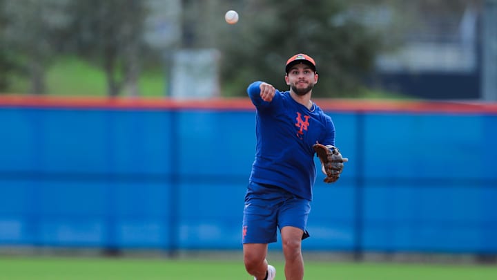 Feb 12, 2025; Port St. Lucie, FL, USA; New York Mets infielder Nick Madrigal (11) throws the baseball during Spring Training workouts at Clover Park. Mandatory Credit: Sam Navarro-Imagn Images