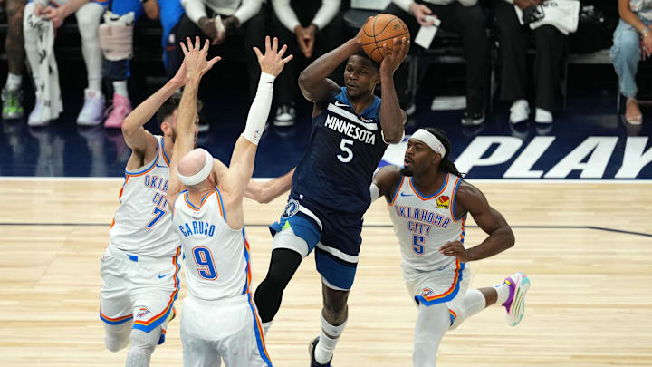 May 26, 2025; Minneapolis, Minnesota, USA; Minnesota Timberwolves guard Anthony Edwards (5) attempts to make a pass against Oklahoma City Thunder guard Alex Caruso (9), guard Luguentz Dort (5) and forward Chet Holmgren (7) in the first half during game four of the western conference finals for the 2025 NBA Playoffs at Target Center. Mandatory Credit: Jesse Johnson-Imagn Images