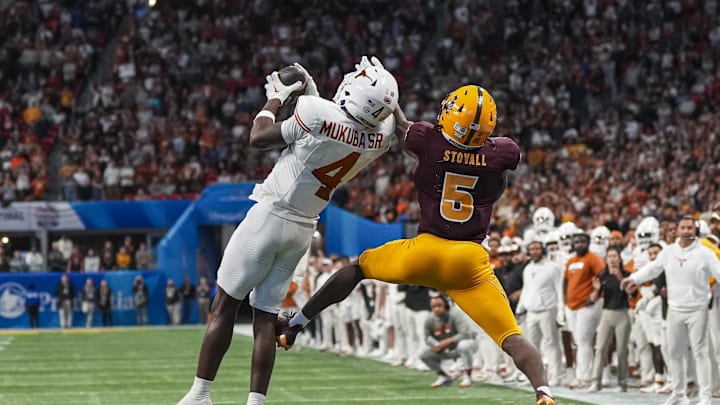 Jan 1, 2025; Atlanta, GA, USA; Texas Longhorns defensive back Andrew Mukuba (4) intercepts a pass in front of Arizona State Sun Devils wide receiver Melquan Stovall (5) to end the game in the second overtime at Mercedes-Benz Stadium. Mandatory Credit: Dale Zanine-Imagn Images
