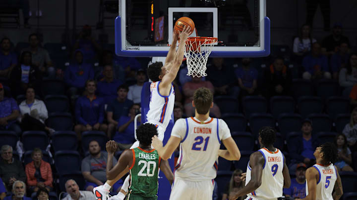 Nov 19, 2024; Gainesville, Florida, USA; Florida Gators guard Walter Clayton Jr. (1) dunks a ball over Florida A&M Rattlers forward Jamine Charles (20) during the first half at Exactech Arena at the Stephen C. O'Connell Center. Mandatory Credit: Morgan Tencza-Imagn Images