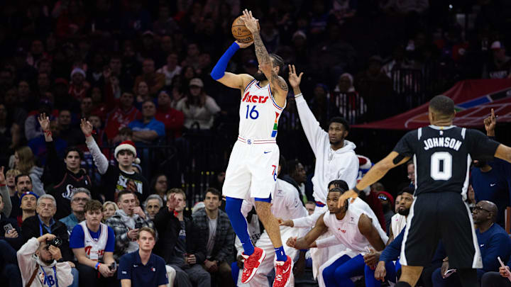 Dec 23, 2024; Philadelphia, Pennsylvania, USA; Philadelphia 76ers forward Caleb Martin (16) shoots a three  pointer against the San Antonio Spurs during the fourth quarter at Wells Fargo Center. Mandatory Credit: Bill Streicher-Imagn Images