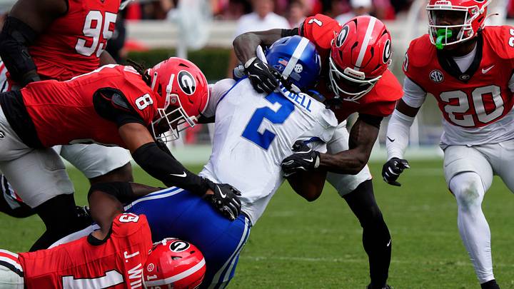 Kentucky running back Dante Dowdell (2) is stopped by Georgia defensive back Ellis Robinson IV (1), Georgia linebacker Justin Williams (19) and Georgia defensive back Joenel Aguero (8) during the second half of a NCAA college football game against Kentucky in Athens, Ga., on Saturday, October 4, 2025.