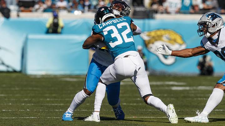 Dec 31, 2023; Jacksonville, Florida, USA; Jacksonville Jaguars corner back Tyson Campbell (32) tackles Carolina Panthers wide receiver Jonathan Mingo (15) during the first quarter at EverBank Stadium. Mandatory Credit: Morgan Tencza-USA TODAY Sports