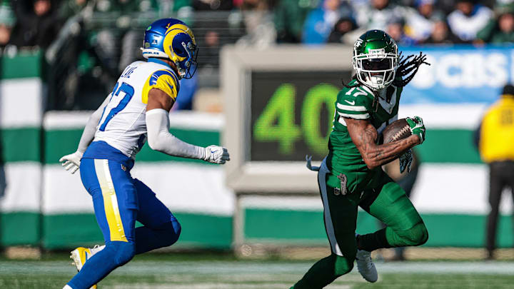 Dec 22, 2024; East Rutherford, New Jersey, USA; New York Jets wide receiver Davante Adams (17) fights for yards as Los Angeles Rams safety Quentin Lake (37) pursues during the first half at MetLife Stadium. Mandatory Credit: Vincent Carchietta-Imagn Images Dec 22, 2024; East Rutherford, New Jersey, USA; New York Jets wide receiver Davante Adams (17) fights for yards as Los Angeles Rams safety Quentin Lake (37) pursues during the first half at MetLife Stadium. Mandatory Credit: Vincent Carchietta-Imagn Images