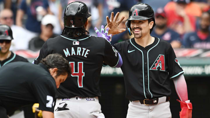 Aug 7, 2024; Cleveland, Ohio, USA; Arizona Diamondbacks second baseman Ketel Marte (4) celebrates after hitting a home run with right fielder Corbin Carroll (7) during the ninth inning against the Cleveland Guardians at Progressive Field. Mandatory Credit: Ken Blaze-USA TODAY Sports