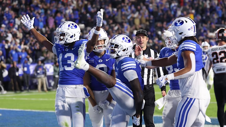 Oct 18, 2024; Provo, Utah, USA; Brigham Young Cougars wide receiver Darius Lassiter (5) celebrates a touchdown with teammates in the last minute of the game against the Oklahoma State Cowboys at LaVell Edwards Stadium. Mandatory Credit: Rob Gray-Imagn Images Oct 18, 2024; Provo, Utah, USA; Brigham Young Cougars wide receiver Darius Lassiter (5) celebrates a touchdown with teammates in the last minute of the game against the Oklahoma State Cowboys at LaVell Edwards Stadium. Mandatory Credit: Rob Gray-Imagn Images