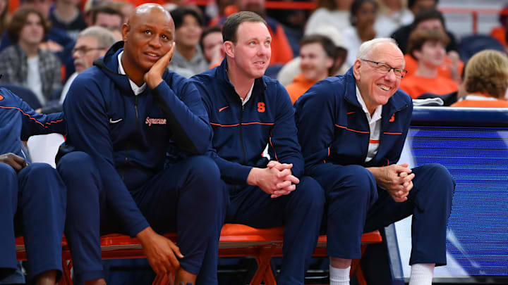 Oct 14, 2022; Syracuse, New York, US; Syracuse Orange associate head coach Adrian Autry (left) and assistant coach Gerry McNamara (center) and head coach Jim Boeheim (right) watch the action at the Orange Tip Off at the JMA Wireless Dome. Mandatory Credit: Rich Barnes-Imagn Images