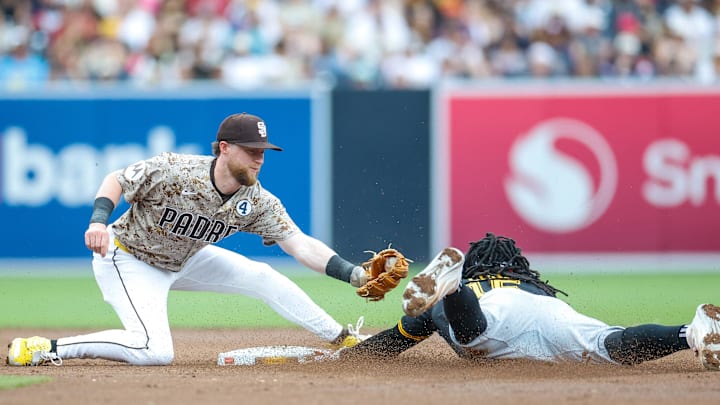 Jun 1, 2025; San Diego, California, USA; Pittsburgh Pirates center fielder Oneil Cruz (15) slides under the tag of San Diego Padres second baseman Jake Cronenworth (9) for a stolen base during the third inning against the San Diego Padres at Petco Park. Mandatory Credit: David Frerker-Imagn Images Jun 1, 2025; San Diego, California, USA; Pittsburgh Pirates center fielder Oneil Cruz (15) slides under the tag of San Diego Padres second baseman Jake Cronenworth (9) for a stolen base during the third inning against the San Diego Padres at Petco Park. Mandatory Credit: David Frerker-Imagn Images