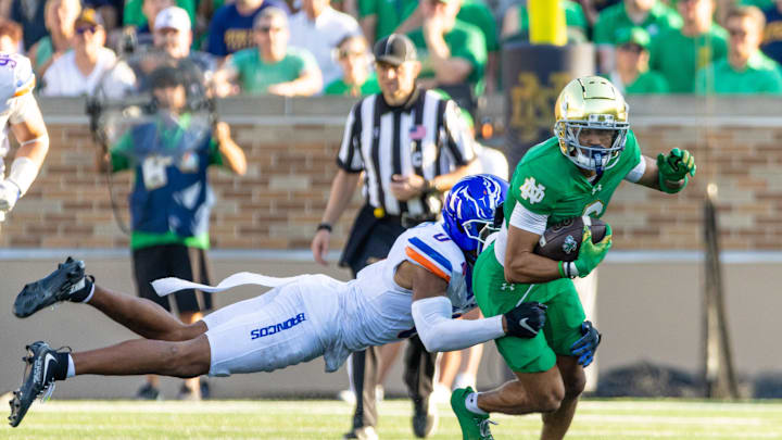 Oct 4, 2025; South Bend, Indiana, USA; Notre Dame Fighting Irish wide receiver Jordan Faison (6) tries to get past Boise State Broncos defensive back Ty Benefield (0) during the second half at Notre Dame Stadium. Mandatory Credit: Michael Caterina-Imagn Images