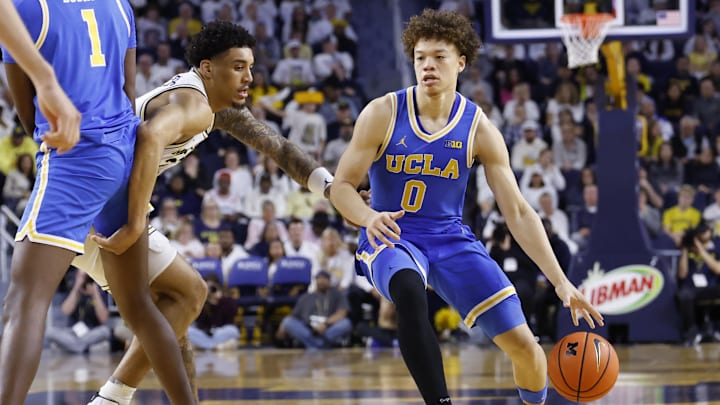 Feb 14, 2026; Ann Arbor, Michigan, USA; UCLA Bruins guard Trent Perry (0) dribbles defended by Michigan Wolverines forward Yaxel Lendeborg (23) in the second half at Crisler Center. Mandatory Credit: Rick Osentoski-Imagn Images Feb 14, 2026; Ann Arbor, Michigan, USA; UCLA Bruins guard Trent Perry (0) dribbles defended by Michigan Wolverines forward Yaxel Lendeborg (23) in the second half at Crisler Center. Mandatory Credit: Rick Osentoski-Imagn Images