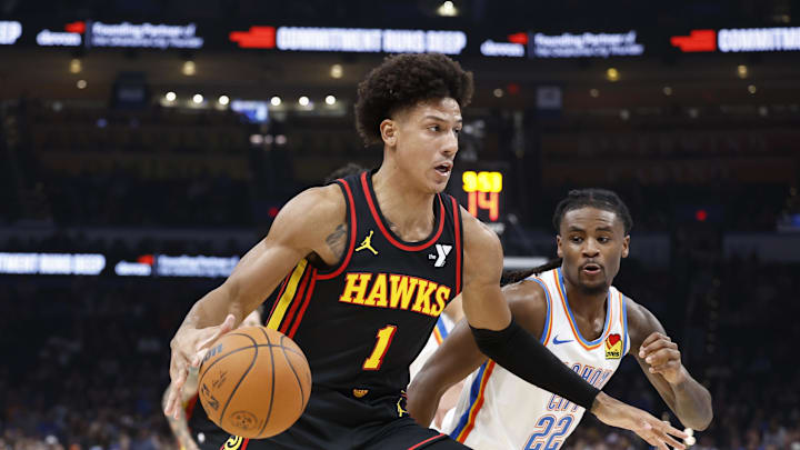 Oct 27, 2024; Oklahoma City, Oklahoma, USA; Atlanta Hawks forward Jalen Johnson (1) drives to the basket around Oklahoma City Thunder guard Cason Wallace (22) during the second quarter at Paycom Center. Mandatory Credit: Alonzo Adams-Imagn Images