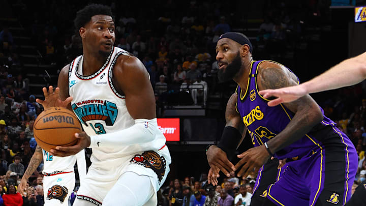 Mar 29, 2025; Memphis, Tennessee, USA; Memphis Grizzlies forward Jaren Jackson Jr. (13) spins to the basket as Los Angeles Lakers forward LeBron James (23) defends during the fourth quarter at FedExForum. Mandatory Credit: Petre Thomas-Imagn Images