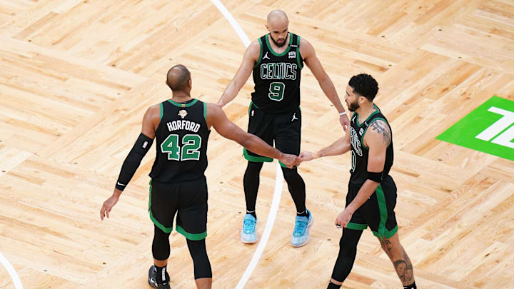 Boston Celtics center Al Horford (42) and guard Derrick White (9) and forward Jayson Tatum (0) celebrate after defeating the Dallas Mavericks in game two of the 2024 NBA Finals at TD Garden. 