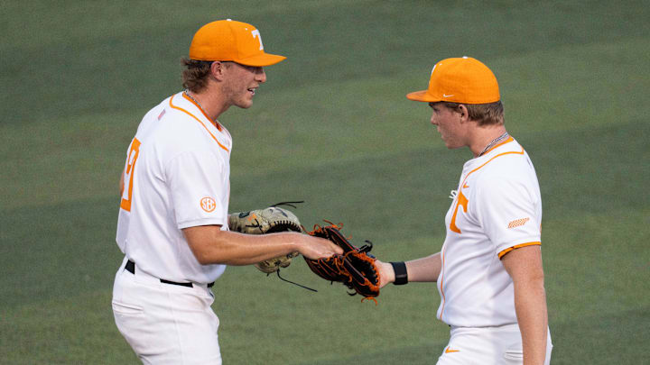 Tennessee's Tanner Franklin (50) hands off the ball to Liam Doyle (12) at the NCAA college baseball Knoxville Regional final against Wake Forest on June 2, 2025, in Knoxville, Tenn.