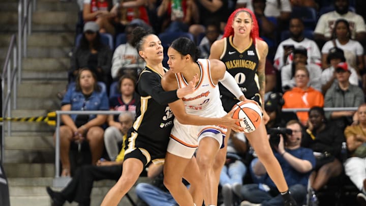 Sep 4, 2025; Washington, District of Columbia, USA;  Washington Mystics forward Alysha Clark (32) defends against Phoenix Mercury forward Satou Sabally (0) during the third quarter at CareFirst Arena. Mandatory Credit: Rafael Suanes-Imagn Images