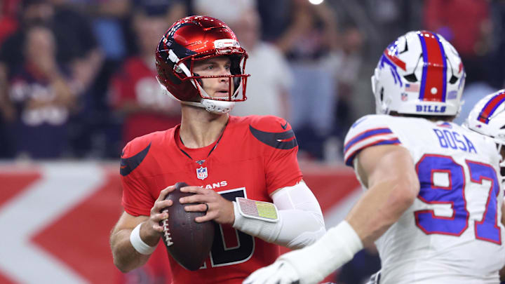 Nov 20, 2025; Houston, Texas, USA; Houston Texans quarterback Davis Mills (10) looks to pass against Buffalo Bills defensive end Joey Bosa (97) in the first quarter at NRG Stadium. Mandatory Credit: Troy Taormina-Imagn Images