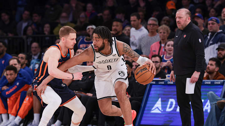 Apr 12, 2024; New York, New York, USA; Brooklyn Nets forward Trendon Watford (9) dribbles against New York Knicks guard Donte DiVincenzo (0) in front of head coach Tom Thibodeau during the second half at Madison Square Garden. Mandatory Credit: Vincent Carchietta-Imagn Images