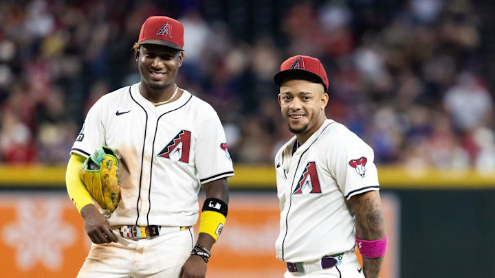 Aug 19, 2025; Phoenix, Arizona, USA; Arizona Diamondbacks infielder Geraldo Perdomo (left) with Ketel Marte against the Cleveland Guardians at Chase Field. Mandatory Credit: Mark J. Rebilas-Imagn Images