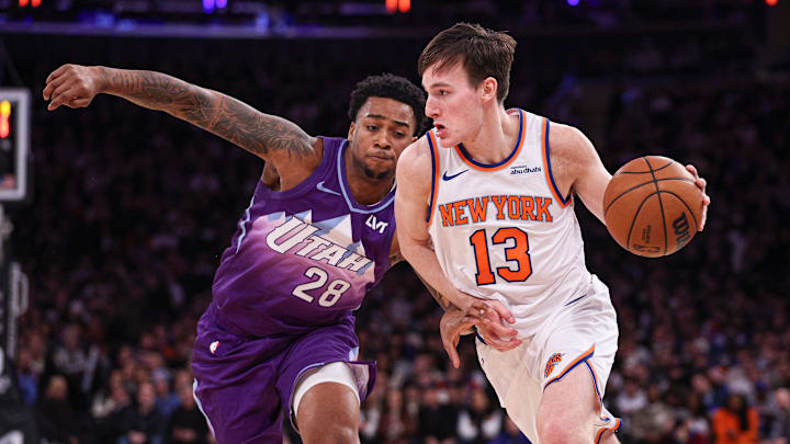 Jan 1, 2025; New York, New York, USA; New York Knicks guard Tyler Kolek (13) dribbles asUtah Jazz forward Brice Sensabaugh (28) defends during the second half at Madison Square Garden. Mandatory Credit: Vincent Carchietta-Imagn Images