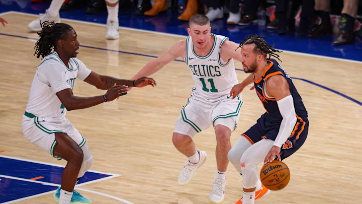 May 12, 2025; New York, New York, USA; New York Knicks guard Jalen Brunson (11) dribbles against Boston Celtics guard Payton Pritchard (11) and Jrue Holiday (4) in the second half during game four of the second round for the 2025 NBA Playoffs at Madison Square Garden. Mandatory Credit: Vincent Carchietta-Imagn Images