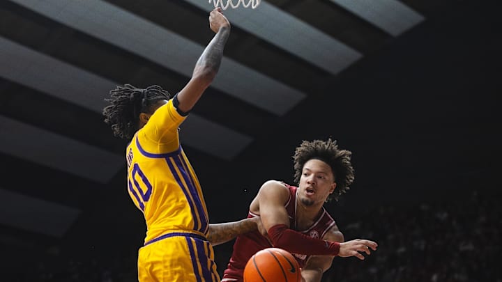 Jan 25, 2025; Tuscaloosa, Alabama, USA; Alabama Crimson Tide guard Mark Sears (right) passes the ball against LSU Tigers forward Daimion Collins (10) during the first half at Coleman Coliseum. Mandatory Credit: Will McLelland-Imagn Images
