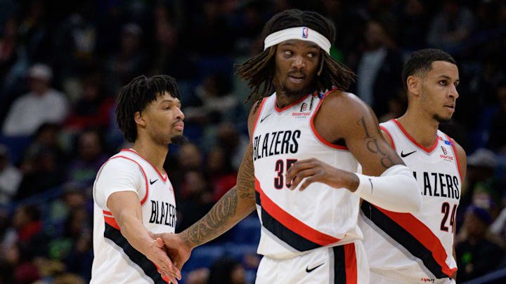 Jan 8, 2025; New Orleans, Louisiana, USA; Portland Trail Blazers guard Anfernee Simons (1) and center Robert Williams III (35) celebrate next to forward Kris Murray (24) during the first half against the New Orleans Pelicans at Smoothie King Center. Mandatory Credit: Matthew Hinton-Imagn Images