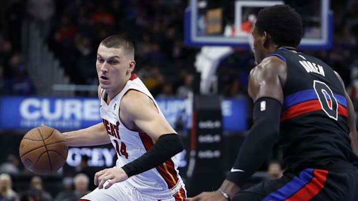 Nov 12, 2024; Detroit, Michigan, USA;  Miami Heat guard Tyler Herro (14) dribbles defended by Detroit Pistons center Jalen Duren (0) in the second half at Little Caesars Arena. Mandatory Credit: Rick Osentoski-Imagn Images